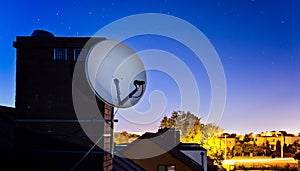 Satellite dish antenna mounted on the roof of the house