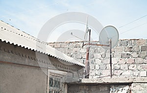 Satellite dish antenna mounted on the wall of a private house