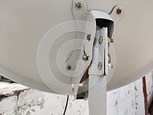 Satellite dish antenna plate fixed with zinc screw and nut, antenna down view close up