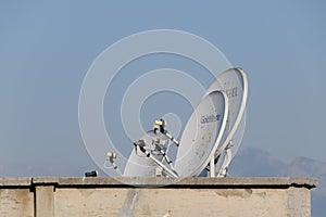 Satellite dish antenna for receiving a television signal on the roof of a