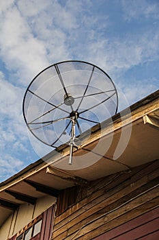 Satellite dish antenna for television on house roof