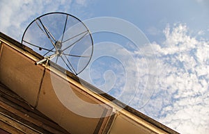 Satellite dish antenna for television on house roof