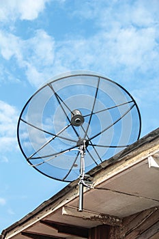 Satellite dish antenna for television on house roof