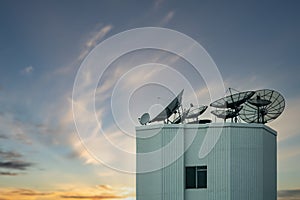 Satellite dish antenna on top of the building with beautiful sky