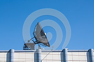 Satellite Dish Antenna on Top of Building, Blue Sky Background