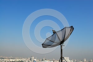 Satellite Dish and Black Aerial Antenna on Rooftop