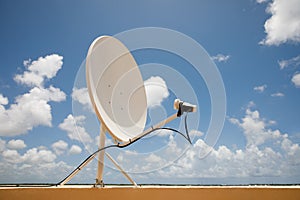 Satellite dish on blue sky background. Parabolic antenna. Reception of the Internet signal from satellites.