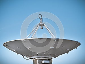 Satellite dish at earth station with a blue sky