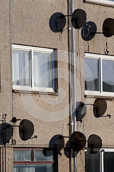 Satellite dish in group on wall of council house