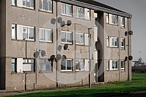 Satellite dish in group on wall of council house