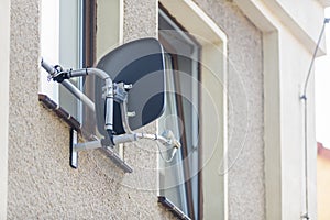 Satellite dish installed in the window area of a house