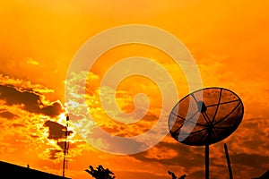 Satellite dish with orange sky