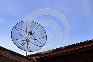 Satellite dish on the roof , blue sky background.