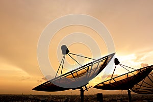 Satellite dish silhouette on twilight sky