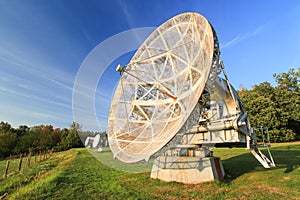 Satellite dish in a summer landscape, sky background.
