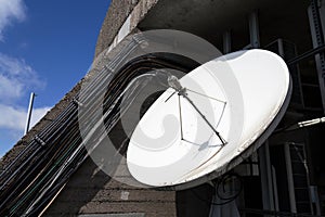 Satellite dish on telecommunication tower on a sunny day