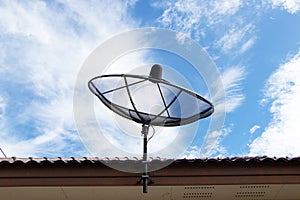 Satellite dish television black net with blue sky white clouds.