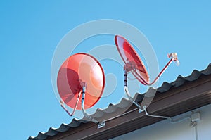 Satellite dish transmission data on background blue sky