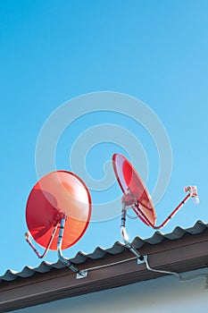 Satellite dish transmission data on background blue sky