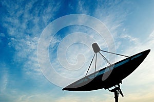 Satellite dish transmission data on blue sky background