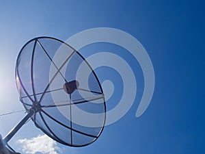 Satellite Dish Transmission Data On Bright Blue Sky Background.