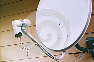 Satellite dish on the wall of a country house