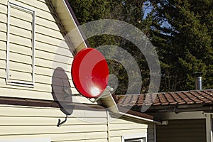 Satellite dish on the wall of a private country house, the concept of installing satellite communications or television