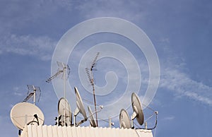 Satellite dishes and digital terrestrial television on a roof of a big city. Copy space