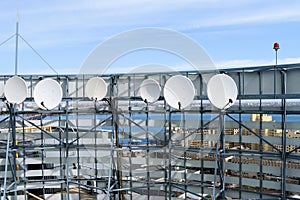 Satellite dishes are on the roof of the building. Television Center