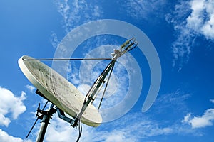 Satellite dishes with sky background.