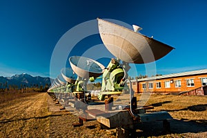 Satellite dishes on summit at sun day