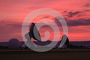 Satellite dishes at sunset