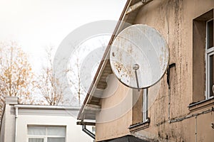 Satellite television dish at the facade of the building