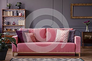 Satin pillows on a pink velvet sofa in a luxurious living room i