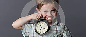 Satirical little kid teasing about time, showing an alarm clock photo