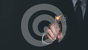 Satisfaction and Customer service concept ,Business man are touching the virtual screen on the happy Smiley face icon to give