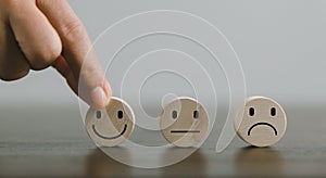 Satisfaction survey concept. Customer services best excellent business rating experience. Hand of business chooses a smile face on