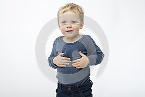 Satisfied baby boy isolated on white background. Cute happy toddler with asking face expression.