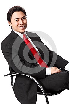 Satisfied businessman sitting in a chair