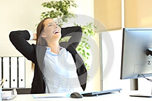 Satisfied businesswoman relaxing at office photo