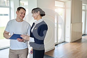 Satisfied buyer signs documents for purchasing a house