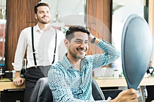 Satisfied Customer Looking At Mirror After The Hairstyling At Sh