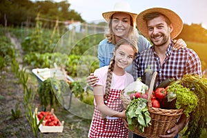 Satisfied farmers family with organic vegetables