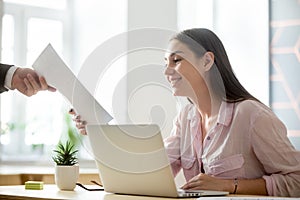 Satisfied female intern getting positive feedback from employer photo