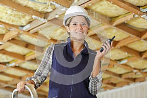 Satisfied female worker on ladder