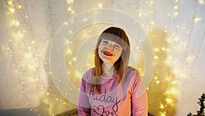 Satisfied girl raving alone in decorated room.