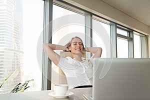 Satisfied happy businesswoman feeling relaxed in office chair, e