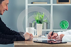 Satisfied happy female patient in hospital office after medical