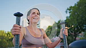 Satisfied lady elliptical machine workout park closeup. Woman ending exercises