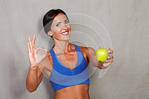 Satisfied lady showing apple and ok sign